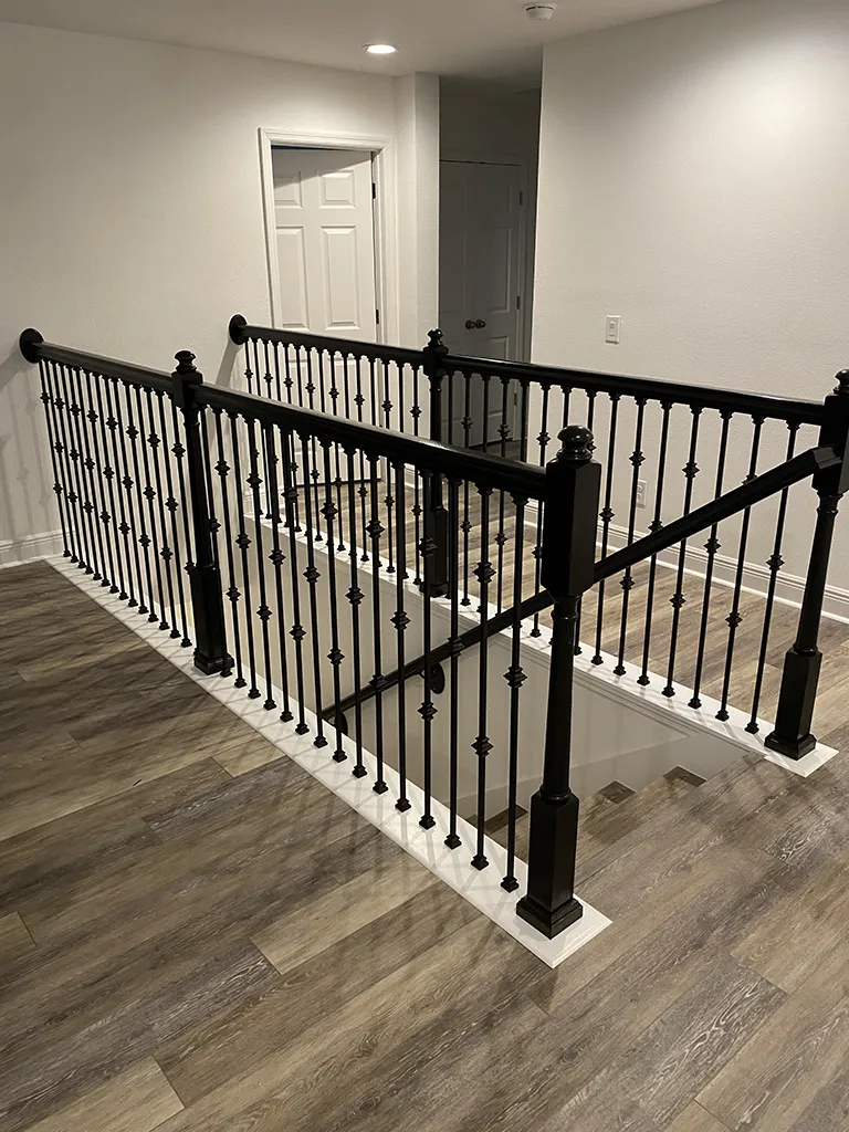 Custom metal and wood staircase railing installation by Ricky G's Handyman Services in Clermont FL